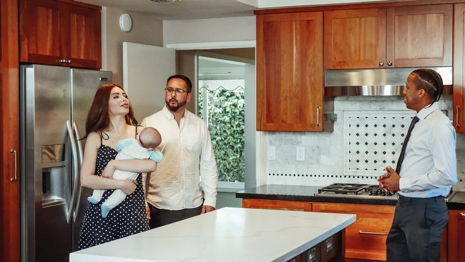 Couple with baby exploring a kitchen with a real estate agent